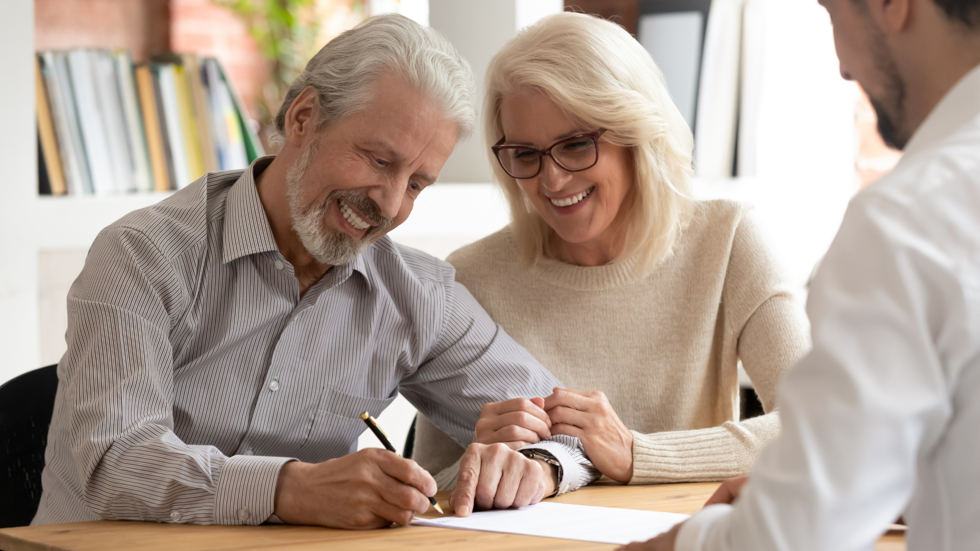 Man and woman signing paperwork